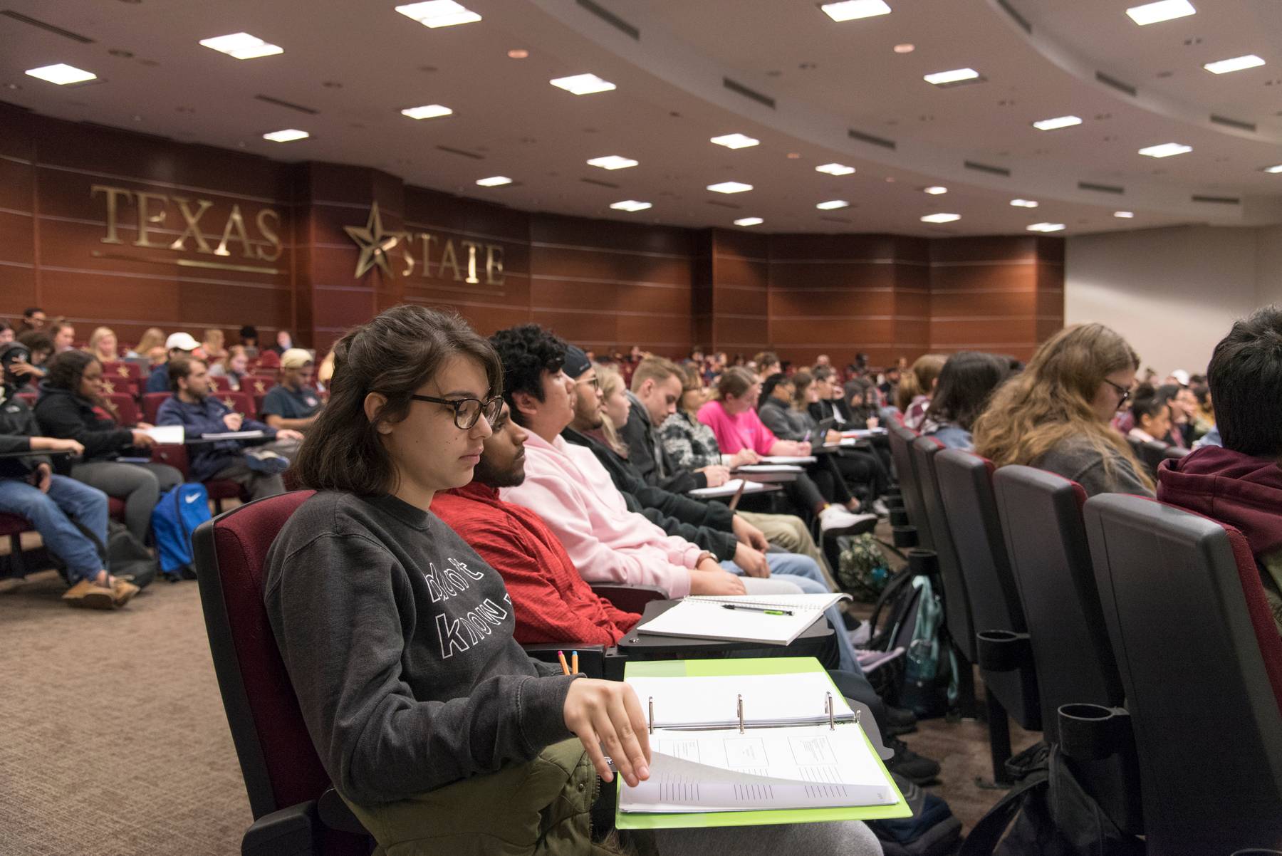 Students sitting in a large classroom