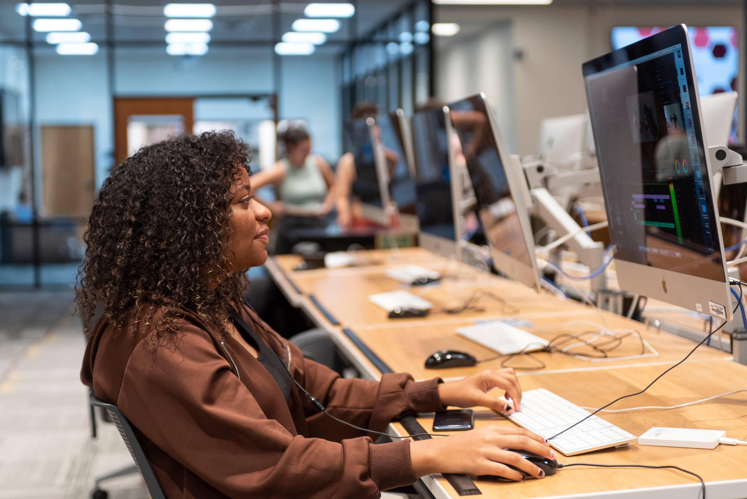 A student sat at a row of computers.